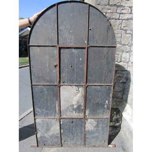 2134 - A reclaimed 19th century iron framed arched window with central bi-opening and enclosing segmented l... 