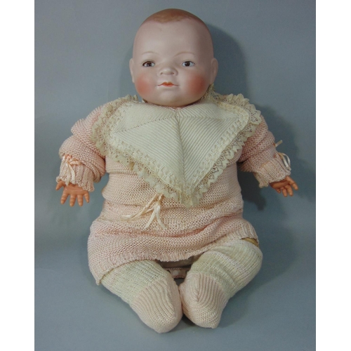 82 - A bisque headed baby doll 