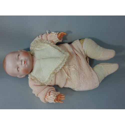 82 - A bisque headed baby doll 