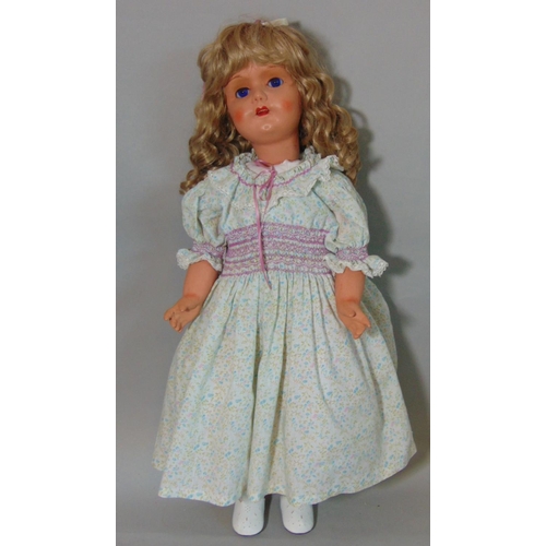 67 - Mid 20th century walking doll, height 70cm, with composition body and closing blue eyes. Head turns ... 