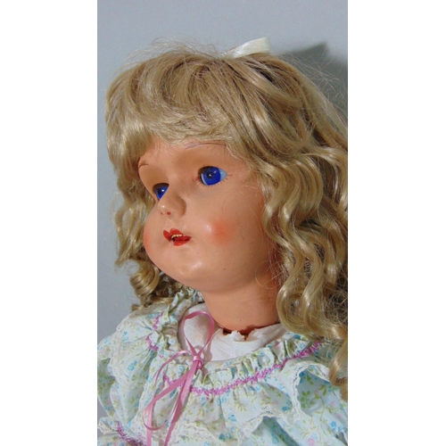 67 - Mid 20th century walking doll, height 70cm, with composition body and closing blue eyes. Head turns ... 