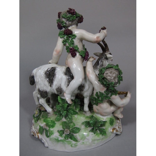 1078 - A 19th century continental figure group of a pair of cherubs, one riding on a goat, with a kid feedi... 