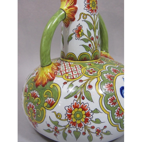 1079 - A 19th century French tin glazed earthenware two handled vase with drawn neck and polychrome painted... 