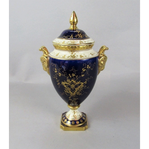 1085 - A Coalport two handled vase and cover with painted fruit decoration by Linda Owen on a dark blue and... 