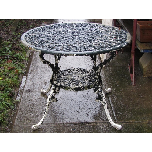 2024 - A painted and weathered cast aluminium garden terrace table of circular form with decorative pierced... 