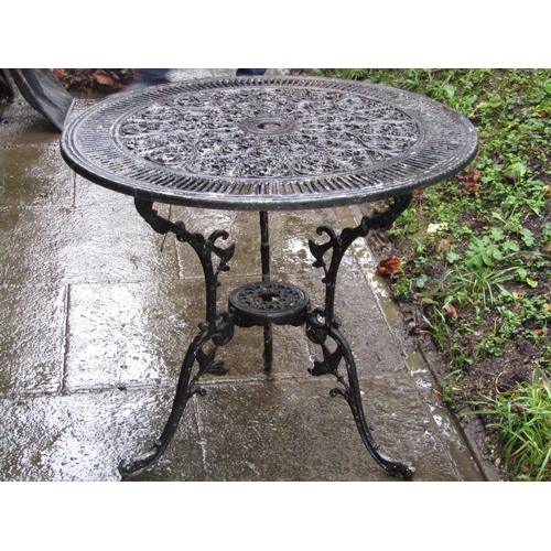 2025 - A cast aluminium garden terrace table of circular form with decorative pierced scrolling acanthus to... 