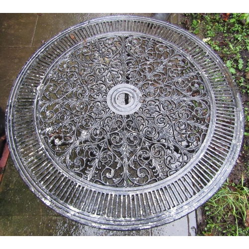 2025 - A cast aluminium garden terrace table of circular form with decorative pierced scrolling acanthus to... 