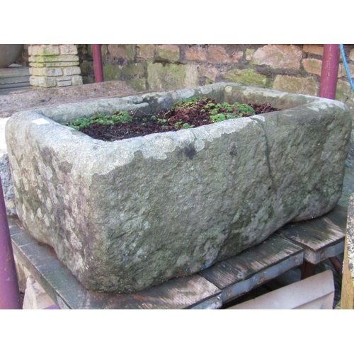 2031 - A weathered natural stone trough of rectangular form (cracked), 62 cm long x 41 cm wide x 26 cm in h... 