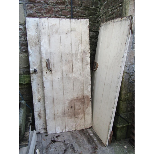 2032 - Seven reclaimed painted pine tongue and groove panelled doors with thumb latches (varying sizes)