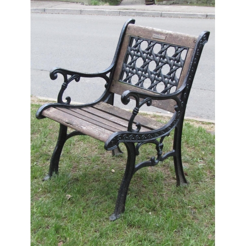 2034 - A heavy cast iron framed four piece garden suite comprising rectangular table, two seat bench and a ... 