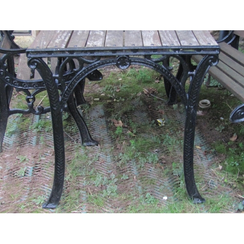 2034 - A heavy cast iron framed four piece garden suite comprising rectangular table, two seat bench and a ... 