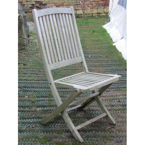 2042 - A weathered contemporary teak garden table of rectangular form with slatted panelled top and square ... 