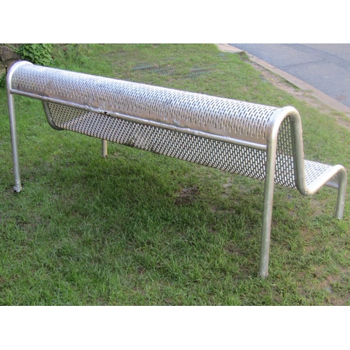 2044 - A municipal park bench with tubular steel frame and repeating pierced pattern seat with over painted... 