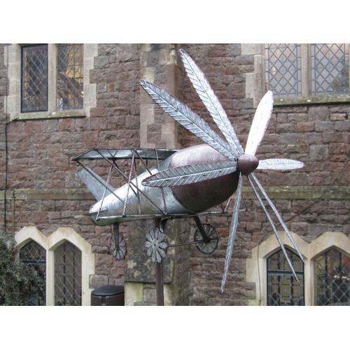 2052 - A novel contemporary light metal garden ornament in the form of a vintage bi-plane with wind generat... 