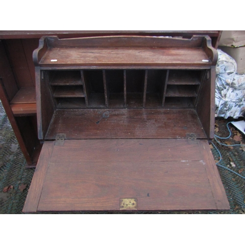 2058 - A vintage child's oak school desk and combined seat together with an early 20th century oak students... 