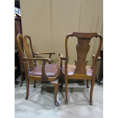 2314 - A pair of Queen Anne style walnut elbow chairs with carved vase shaped splats, with hide upholstered... 