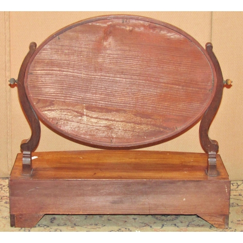 2287 - A Georgian mahogany toilet mirror of oval form raised on a bow fronted box base fitted with three fr... 