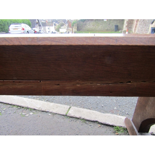 2107 - A small 19th century oak church pew with plank seat, chamfered frame and sledge supports 150 cm long... 