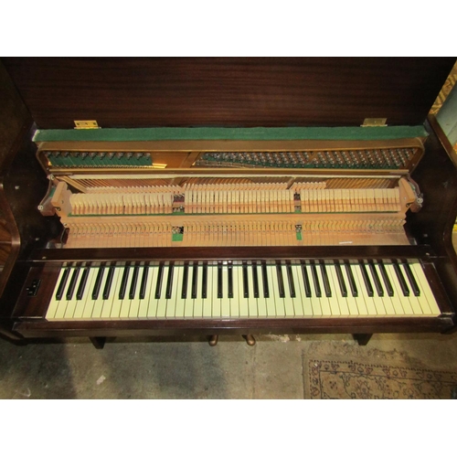 2162 - A Kemble upright iron framed and over strung piano together with an associated piano stool with upho... 