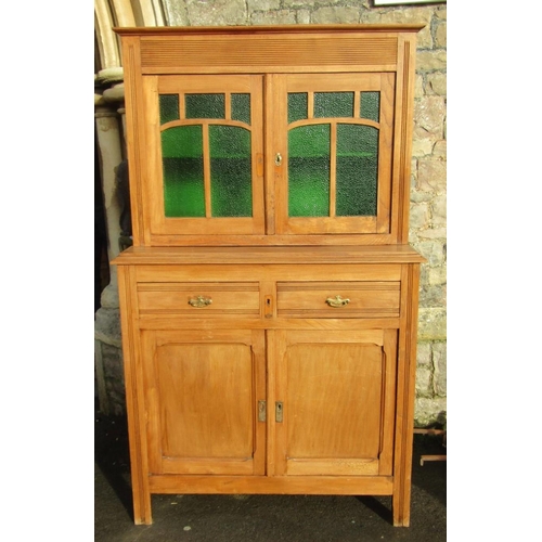 2223 - A continental stripped kitchen dresser in two sections, the lower enclosed by a pair of rectangular ... 