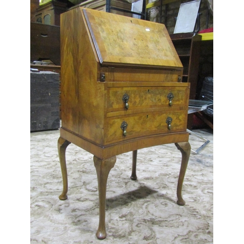 2255 - A small, reproduction Queen Anne style, walnut veneered ladies writing bureau, the fall flap enclosi... 