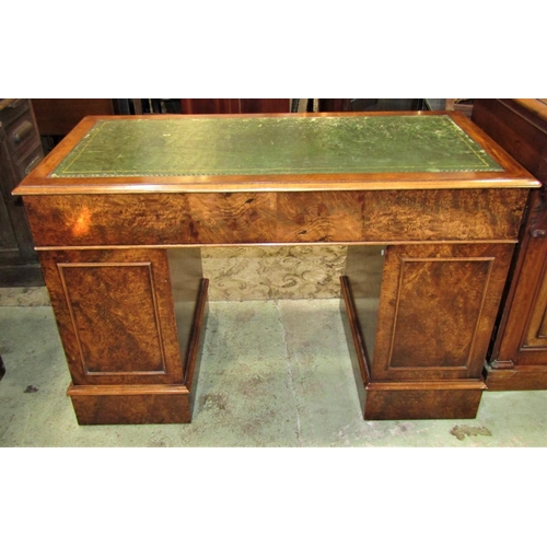 2263 - A reproduction Georgian style walnut veneered kneehole twin pedestal desk with inset green leather w... 