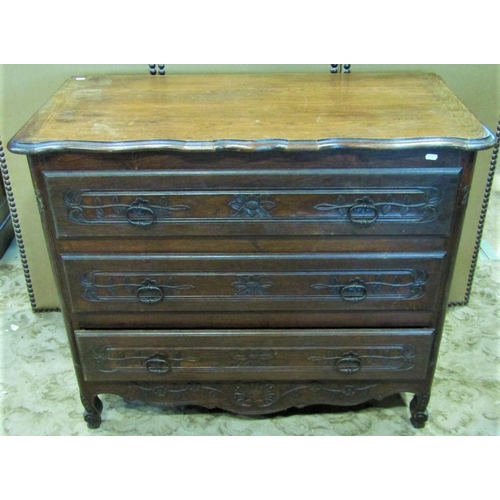 2284 - An antique oak commode of three long drawers with carved foliate detail over a shaped apron and squa... 