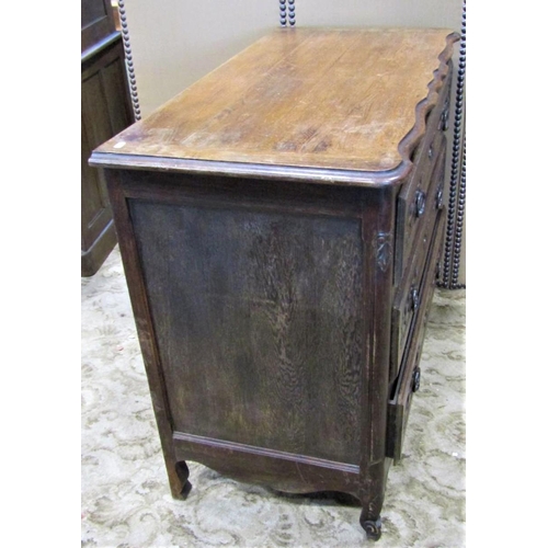 2284 - An antique oak commode of three long drawers with carved foliate detail over a shaped apron and squa... 