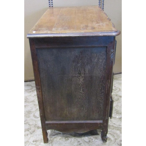 2284 - An antique oak commode of three long drawers with carved foliate detail over a shaped apron and squa... 