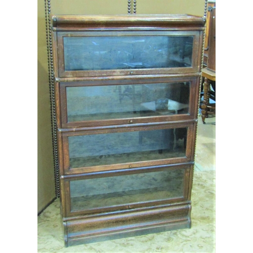 2286 - A floorstanding four sectional library bookcase with anodised fittings enclosed by up and over glaze... 