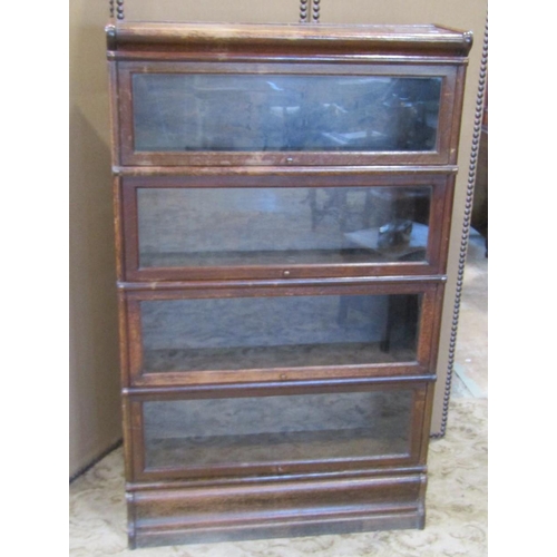 2286 - A floorstanding four sectional library bookcase with anodised fittings enclosed by up and over glaze... 