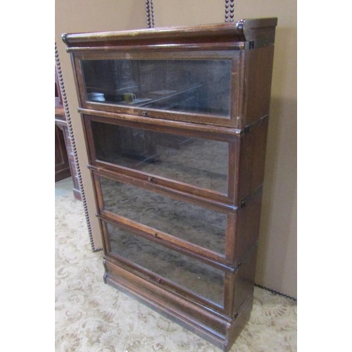 2286 - A floorstanding four sectional library bookcase with anodised fittings enclosed by up and over glaze... 