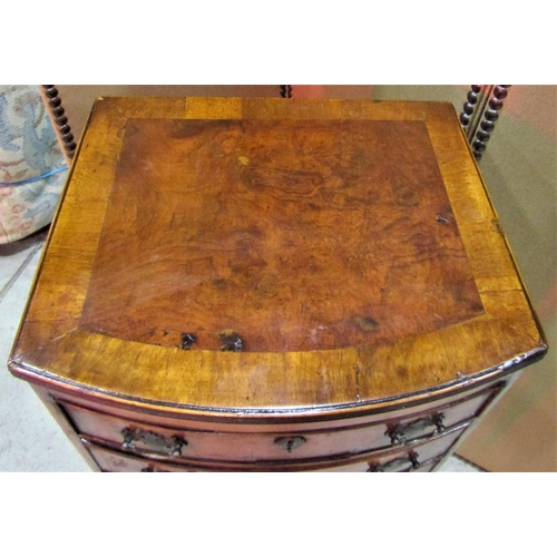 2294 - A Georgian style walnut veneered bow fronted chest of six long oak lined bow fronted drawers over a ... 