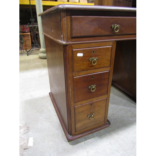 2299 - A small Victorian mahogany kneehole twin pedestal desk with inset green leather panelled top over an... 