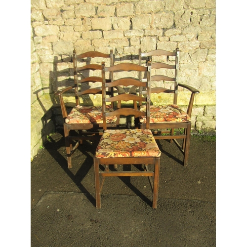 2321 - A pair of dark stained Ercol elm and beechwood ladderback carver chairs with slatted seats together ... 