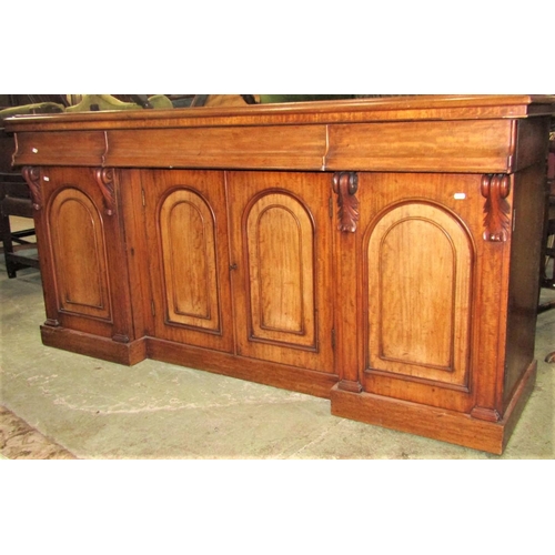 2333 - A Victorian mahogany sideboard fitted with three ogee moulded frieze drawers over four arched and mo... 