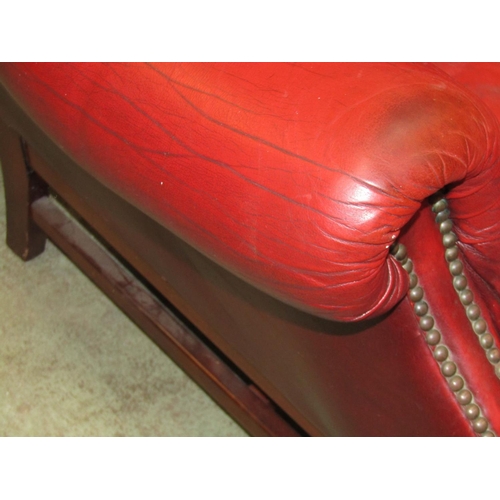 2398 - A contemporary Georgian style red leather upholstered wing armchair with button back and loose squab... 