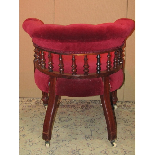 2310 - A Victorian library chair with upholstered seat and buttoned horseshoe shaped back rail raised on tu... 