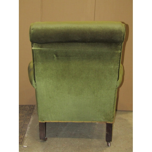 2322 - A late Victorian/Edwardian easy chair with scrolled arms, rounded seat and turned forelegs