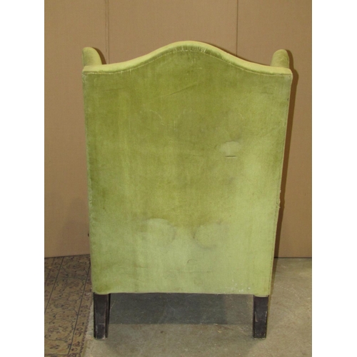 2324 - A Georgian style wing armchair with green dralon upholstered finish and squat cabriole forelegs