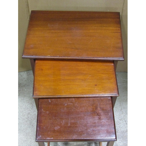 2341 - A nest of three Edwardian mahogany occasional tables of rectangular form raised on slender square ta... 