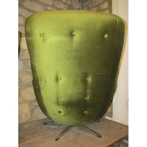 2408 - A vintage swivel egg type chair upholstered in green dralon with buttoned cushioned back raised on a... 