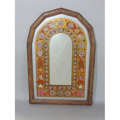 534 - A decorative wall mirror in the form an arched window with foliate running borders, 48 cm x 33 cm