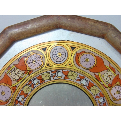 534 - A decorative wall mirror in the form an arched window with foliate running borders, 48 cm x 33 cm