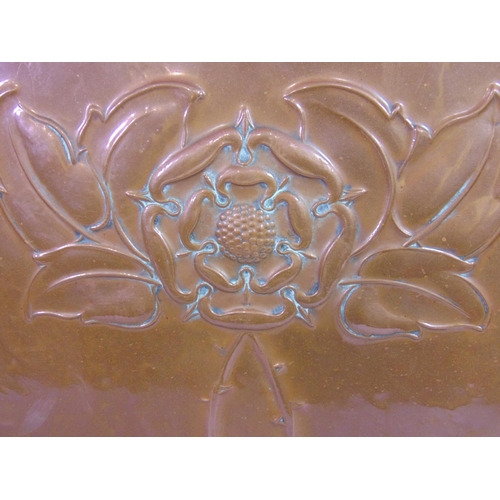 538 - An Arts & Crafts iron framed firescreen enclosing a copper panel with embossed rose design 67 cm hig... 