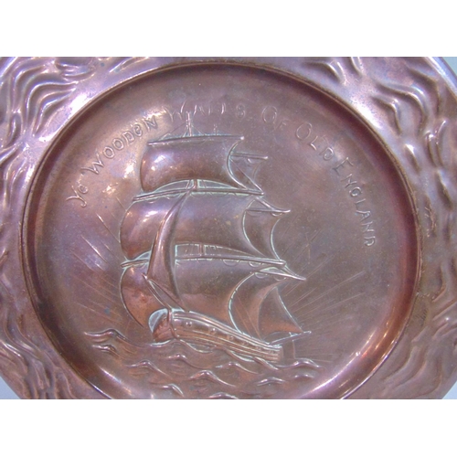 541 - An Arts & Crafts style copper charger with embossed galleon design and script Ye Wooden Walls of old... 