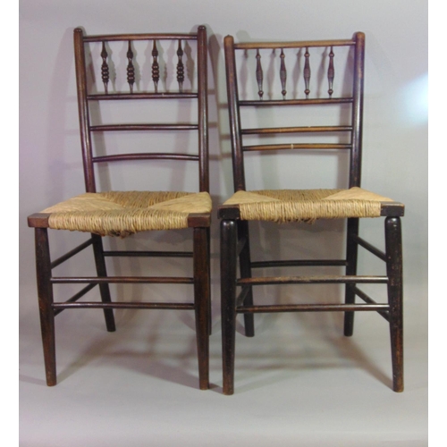 542 - Two similar Arts & Crafts Sussex dining chairs with stained ebonised frames, turned spindle backs an... 