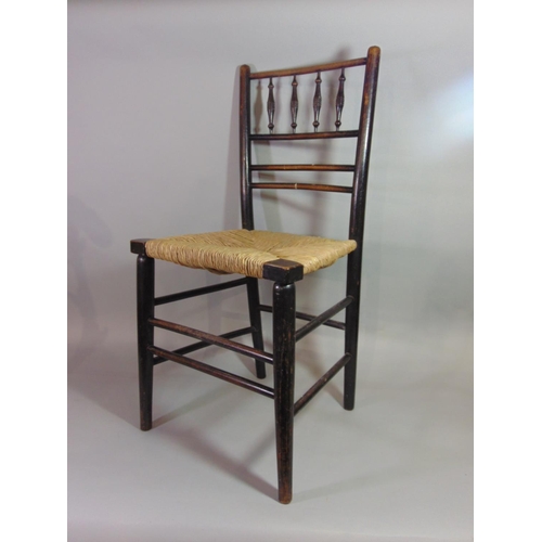 542 - Two similar Arts & Crafts Sussex dining chairs with stained ebonised frames, turned spindle backs an... 