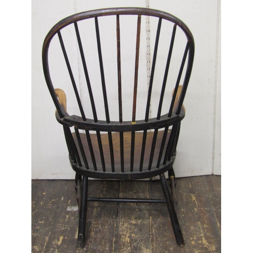 2650 - 18th century Windsor stick back elbow chair in mixed woods, the elm seat raised on turned supports a... 