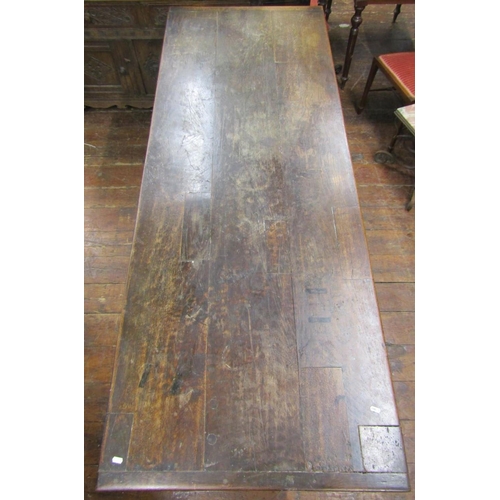 2654 - An antique oak refectory table, the plank top with cleated ends over a carved frieze (to all sides),... 